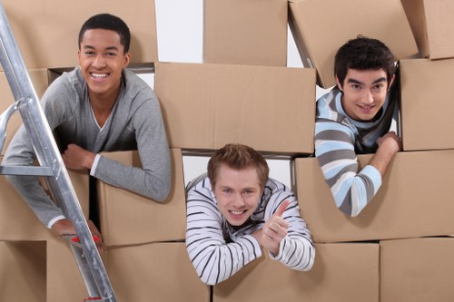 Loading household items into a removals vehicle near local housing